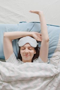 woman stretching in bed