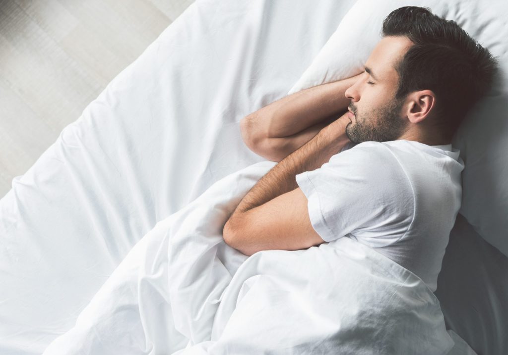Man in white sleeping peacefully